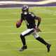 NOVEMBER 22: Lamar Jackson #8 of the Baltimore Ravens rolls out against the Tennessee Titans during the game at M&T Bank Stadium on November 22, 2020 in Baltimore, Maryland.